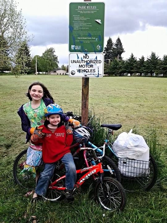 kids doing neighborhood clean up on bikes