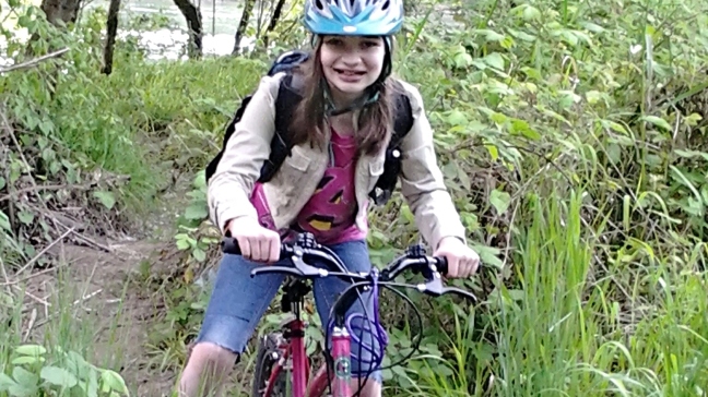 girl trail riding on a mountain bike